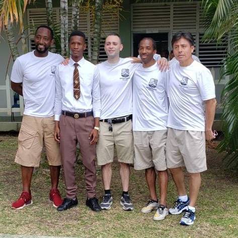     NYPD soccer team members with a student 